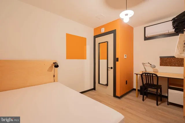 a bedroom with a bed and a table in it