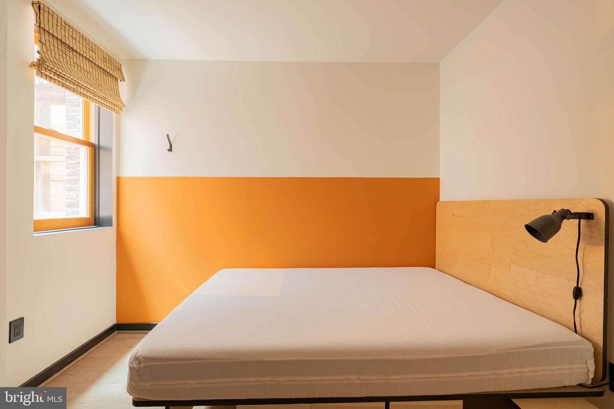 1480 Chapin Street Northwest, Unit 4 1 Washington, DC 20009 - Photo 6 of 23 a bed sitting in a bedroom next to a window