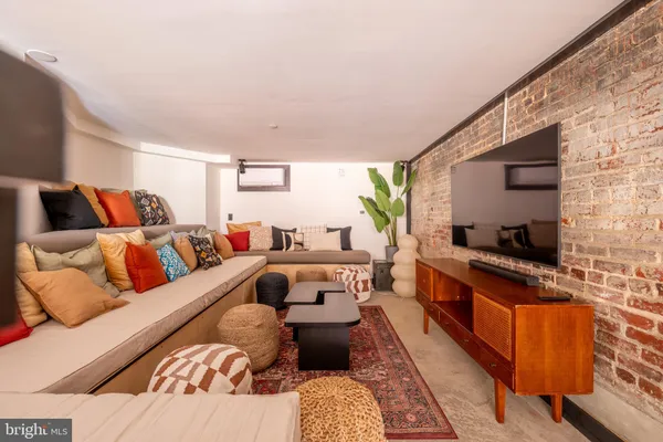 a large bedroom with a bed and a flat screen tv