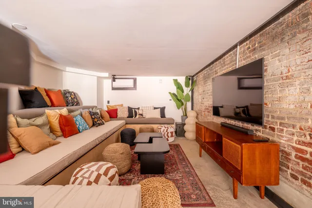 a large bedroom with a bed and a flat screen tv