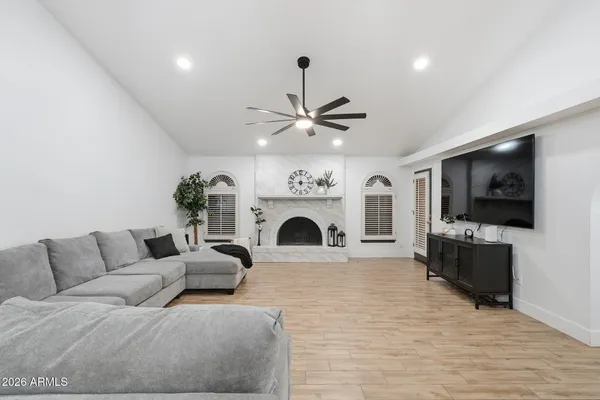 a living room with furniture a fireplace and a flat screen tv