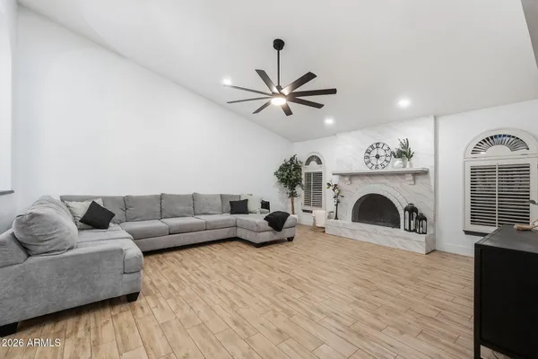 a living room with furniture a fireplace and a flat screen tv