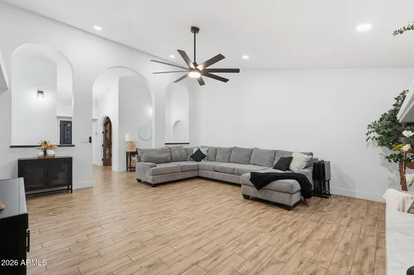 a living room with furniture a flat screen tv and a fireplace