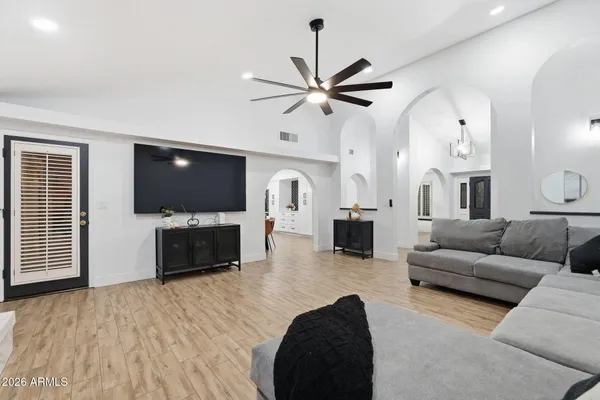 a kitchen with a sink a stove a refrigerator and chairs