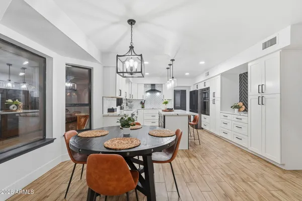 a kitchen with a refrigerator and a stove top oven