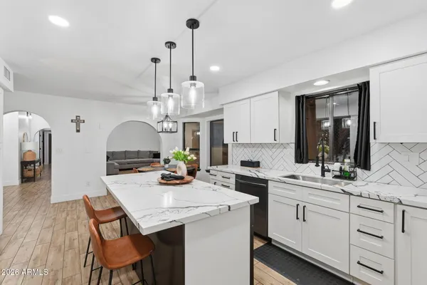 a kitchen with stainless steel appliances white cabinets and a refrigerator