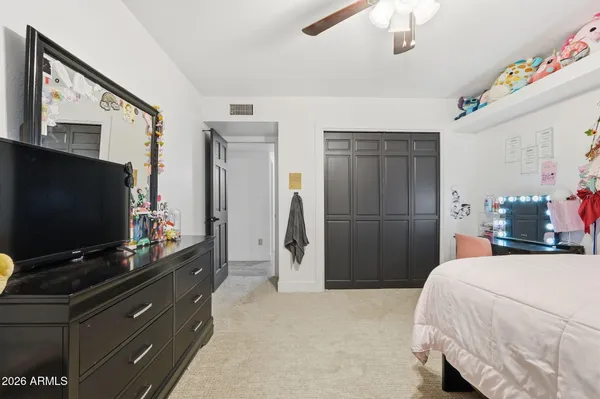 a bedroom with a bed and a flat screen tv