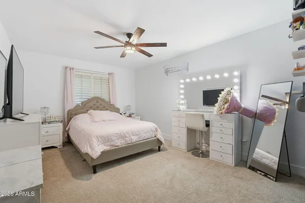 a bedroom with a bed dresser and a window