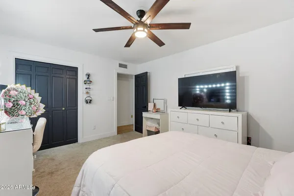 a bedroom with a bed and a flat screen tv