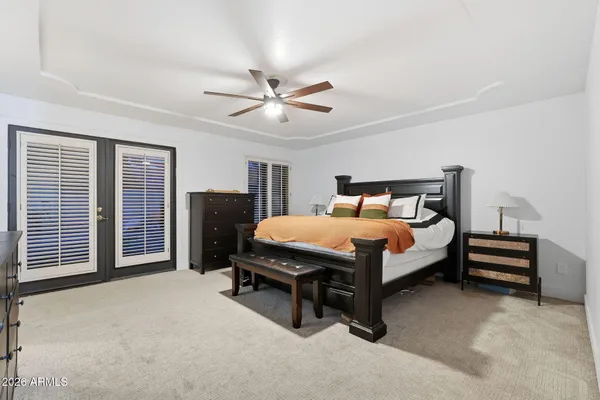 a bedroom with a bed couch and window