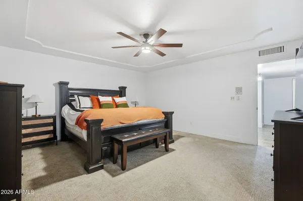 a bedroom with a bed and a chandelier