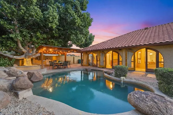 a view of a house with swimming pool and sitting area