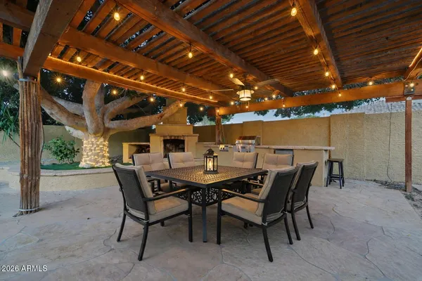 a view of a backyard with plants and a fountain