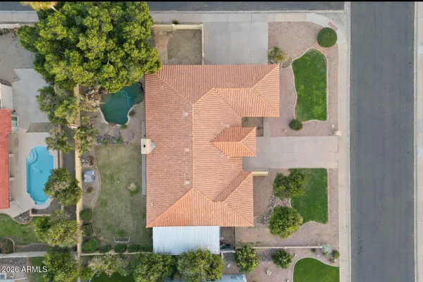 an aerial view of a house with a yard