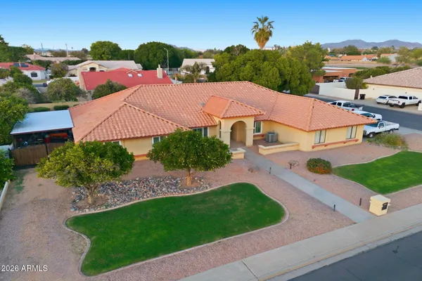 an aerial view of a house with garden space and street view