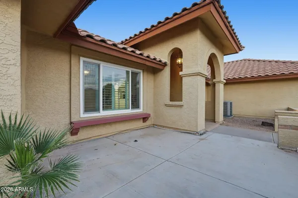 a view of house with backyard and glass door