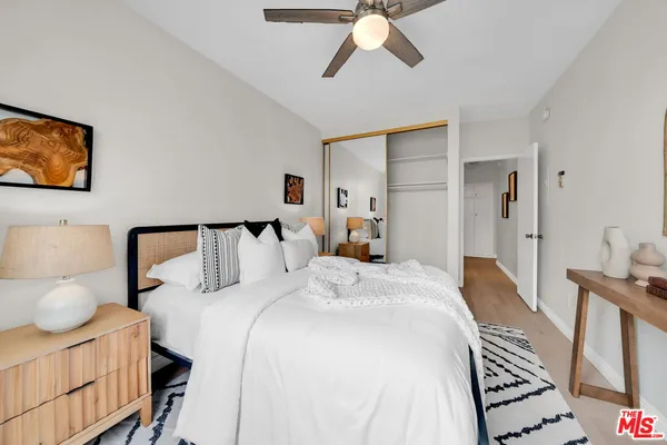 a bedroom with a bed and a dresser with the mirror