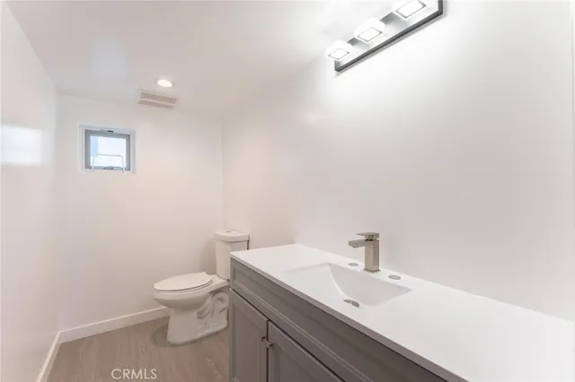 a white toilet sitting next to a bathroom sink