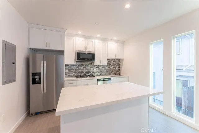 a kitchen with stainless steel appliances a refrigerator and a stove