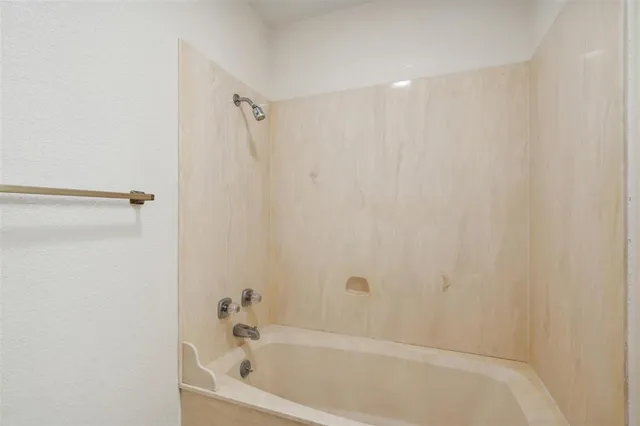 a bathroom with a tub and shower