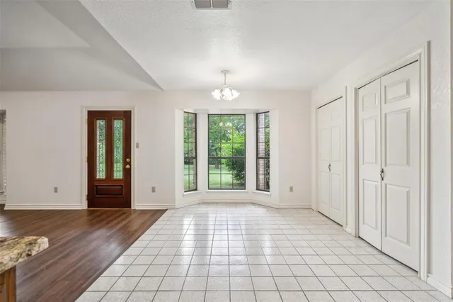 a view of a room with window and hardwood floor