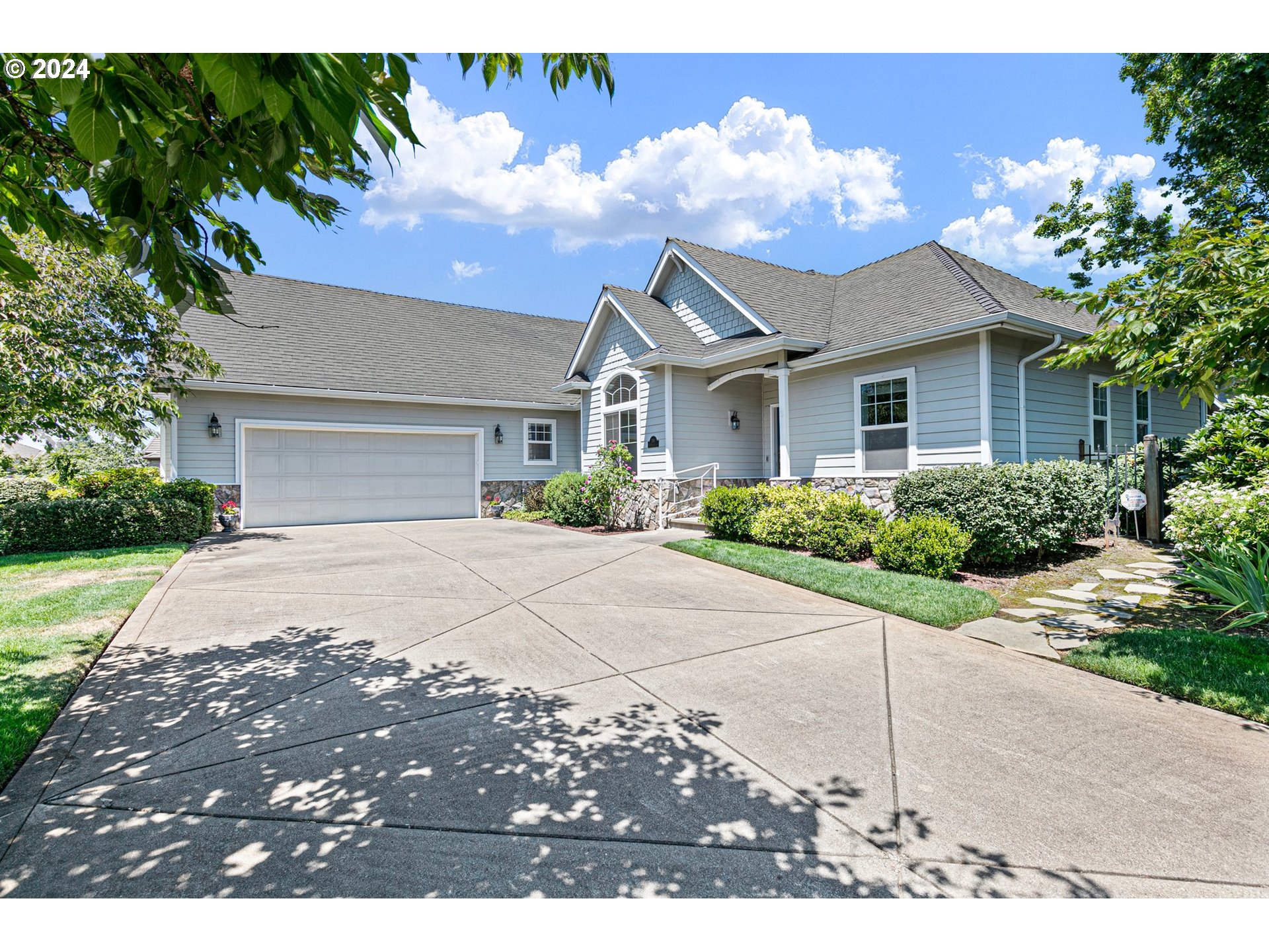 a front view of a house with a yard and a garage