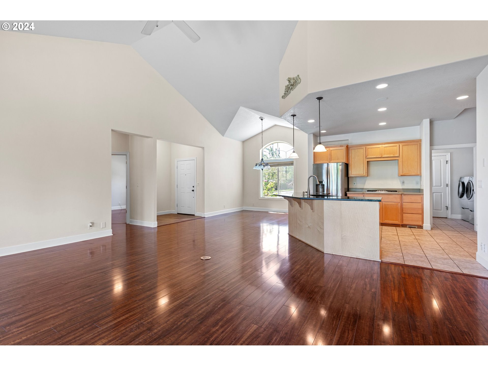 790 Old Orchard Lane Springfield, OR 97477 - Photo 12 of 46 a view of a big room with wooden floor and a kitchen