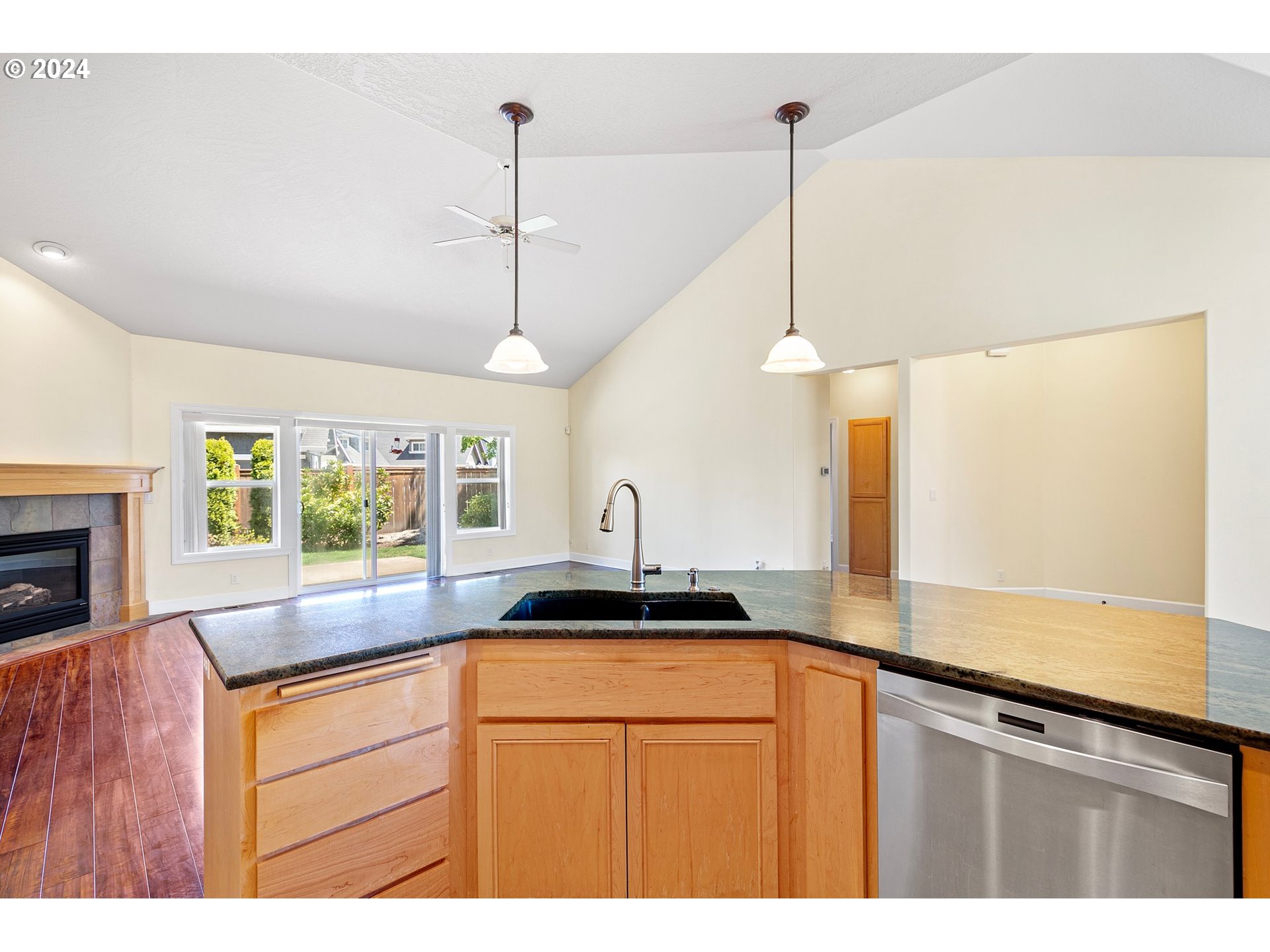 790 Old Orchard Lane Springfield, OR 97477 - Photo 14 of 46 a kitchen with stainless steel appliances granite countertop a sink a counter space and a window