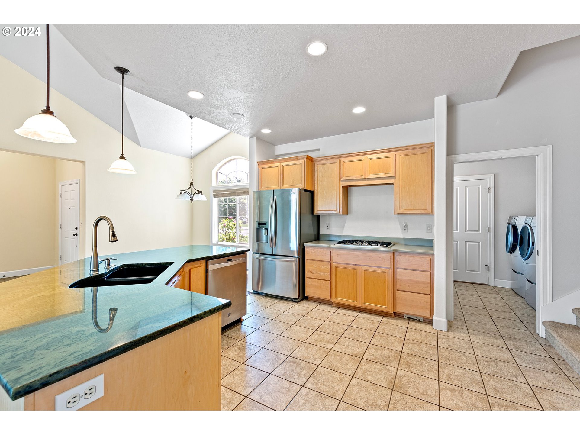 790 Old Orchard Lane Springfield, OR 97477 - Photo 15 of 46 a kitchen with stainless steel appliances granite countertop a sink and a refrigerator