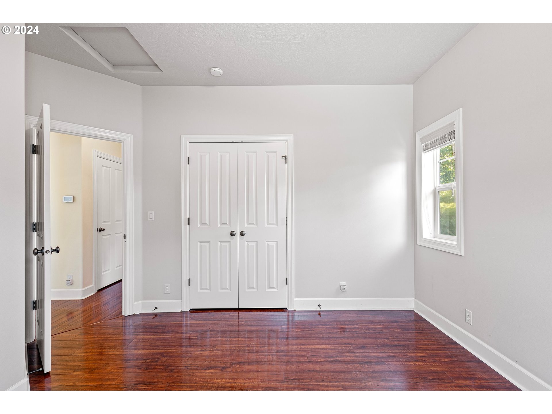 790 Old Orchard Lane Springfield, OR 97477 - Photo 22 of 46 a view of an empty room with wooden floor and window