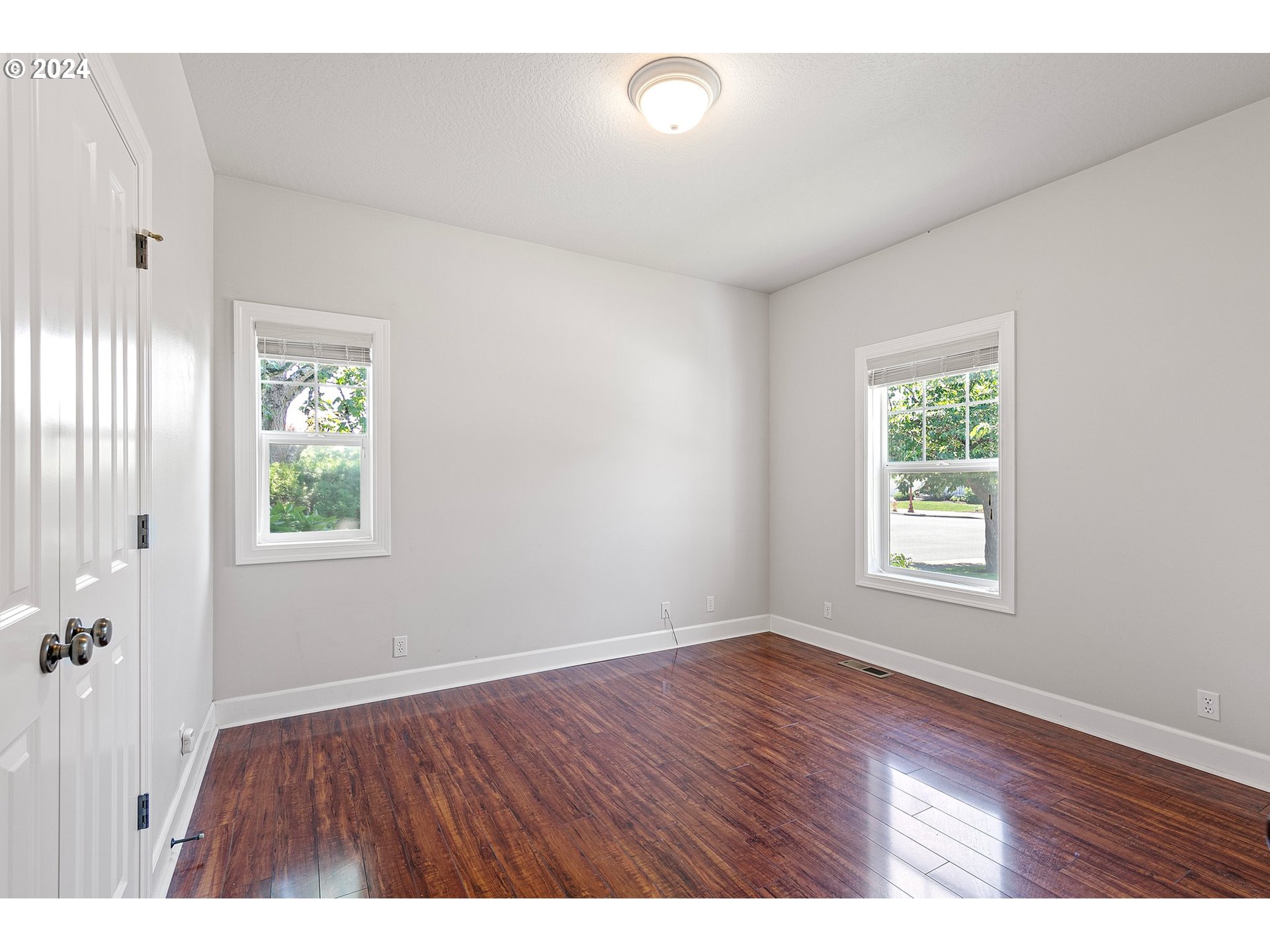 790 Old Orchard Lane Springfield, OR 97477 - Photo 23 of 46 a view of an empty room with wooden floor and a window
