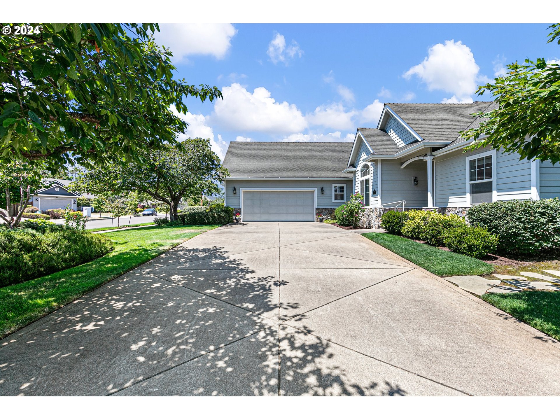 790 Old Orchard Lane Springfield, OR 97477 - Photo 3 of 46 a front view of a house with a yard and a garage