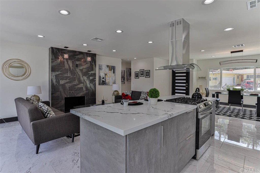 945 Oban Drive Los Angeles, CA 90065 - Photo 13 of 60 a large kitchen with stainless steel appliances kitchen island granite countertop a table and chairs