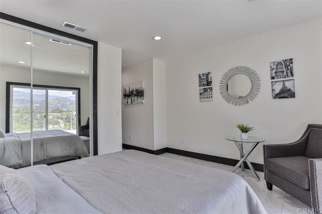 945 Oban Drive Los Angeles, CA 90065 - Photo 25 of 60 a bedroom with a bed and a lamp