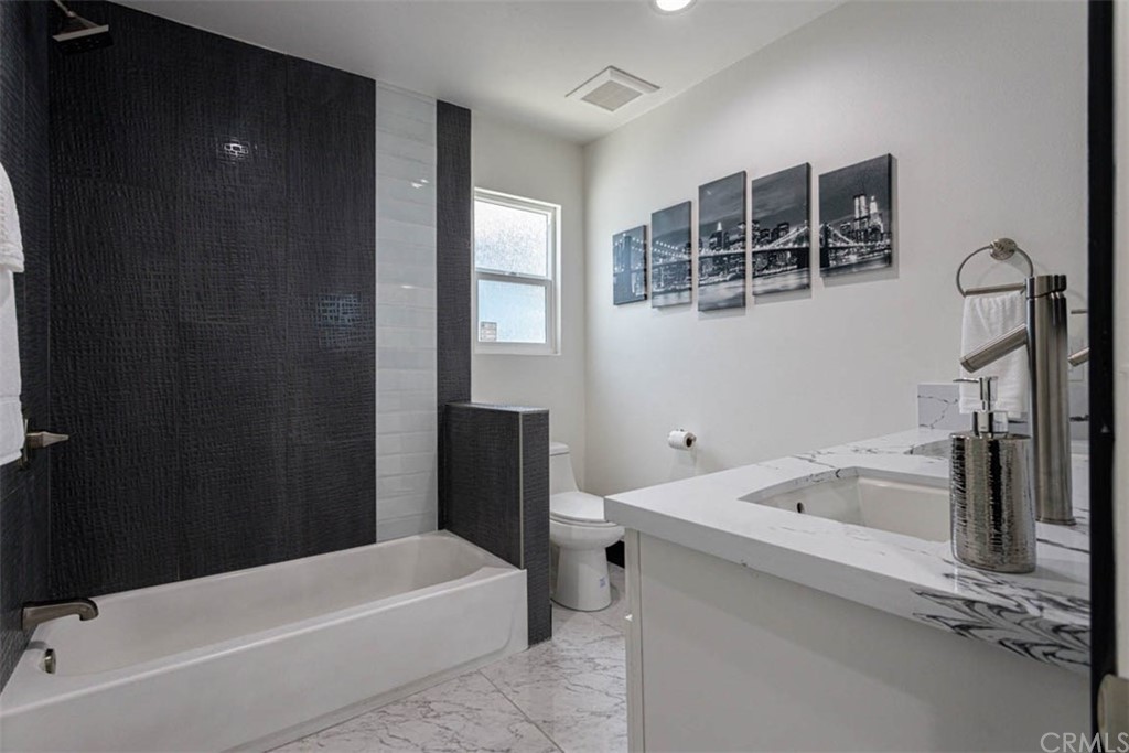 945 Oban Drive Los Angeles, CA 90065 - Photo 26 of 60 a bathroom with a tub sink and mirror