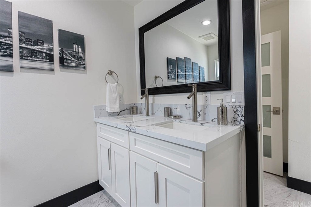 945 Oban Drive Los Angeles, CA 90065 - Photo 29 of 60 a bathroom with a sink and a mirror