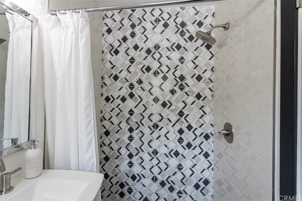 945 Oban Drive Los Angeles, CA 90065 - Photo 30 of 60 a bathroom with a shower curtain