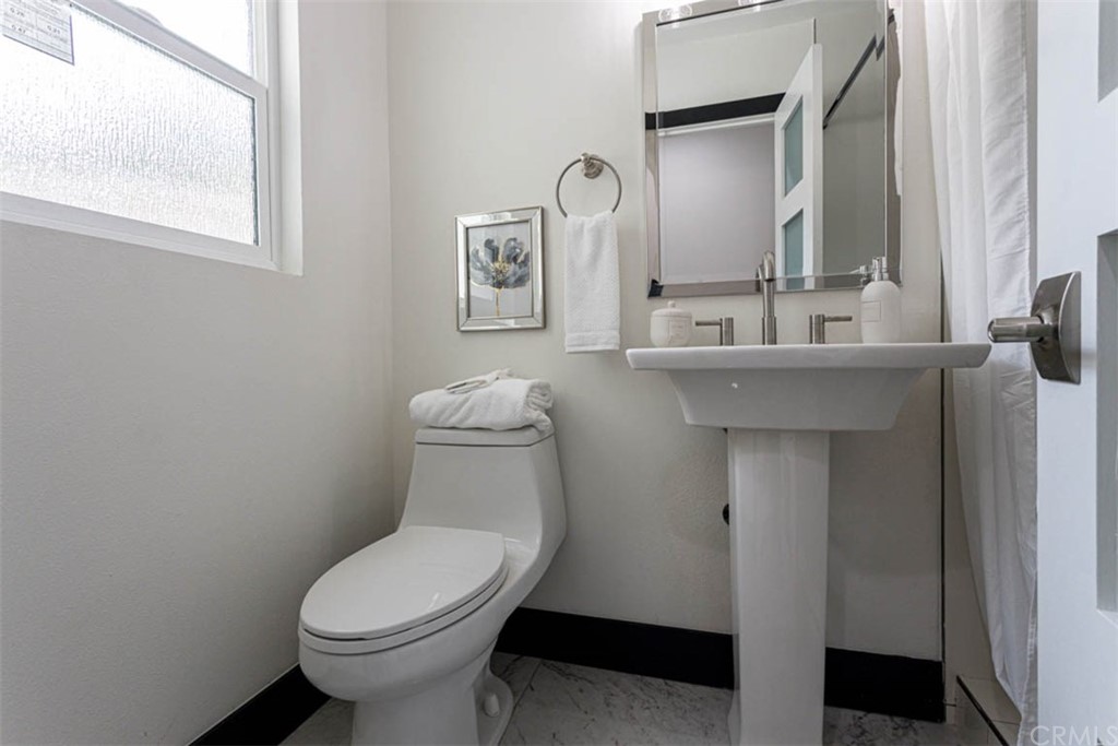 945 Oban Drive Los Angeles, CA 90065 - Photo 31 of 60 a bathroom with a toilet sink and mirror