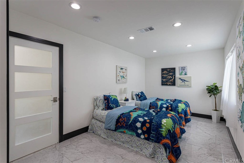 945 Oban Drive Los Angeles, CA 90065 - Photo 36 of 60 a bed room with a bed a couch and potted plant