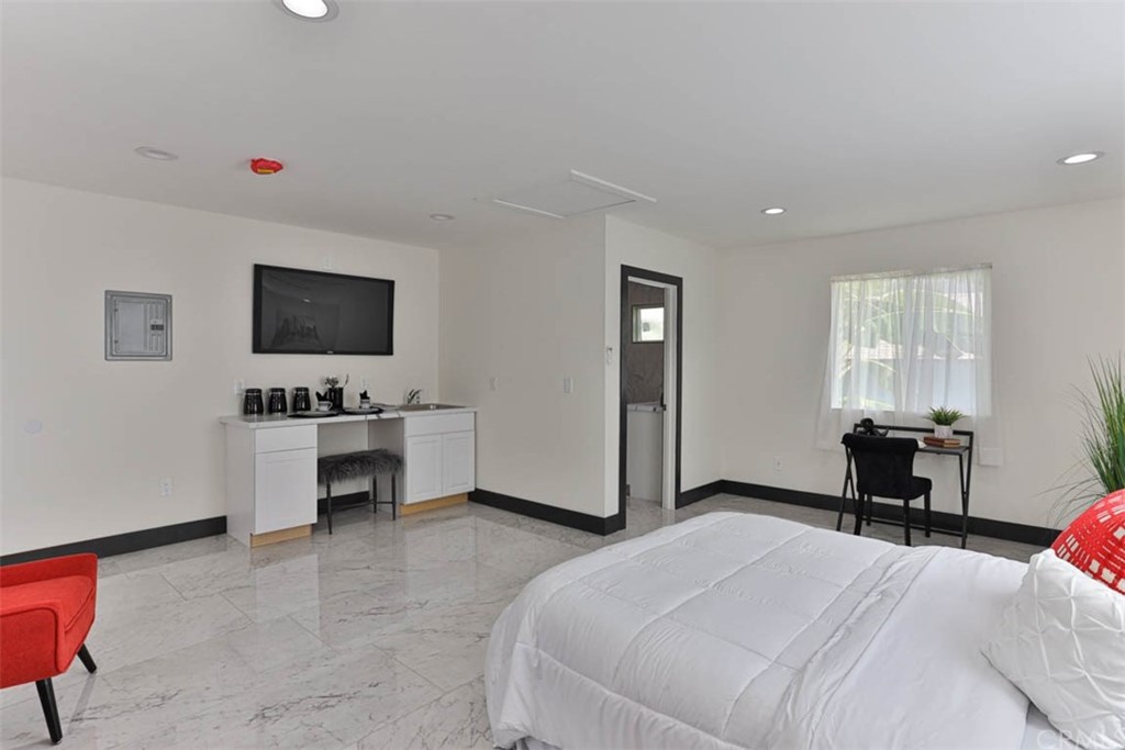 945 Oban Drive Los Angeles, CA 90065 - Photo 44 of 60 a bedroom with a bed and a flat screen tv