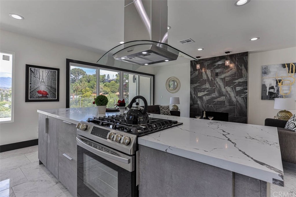 945 Oban Drive Los Angeles, CA 90065 - Photo 9 of 60 a kitchen with stainless steel appliances kitchen island granite countertop a stove and a sink