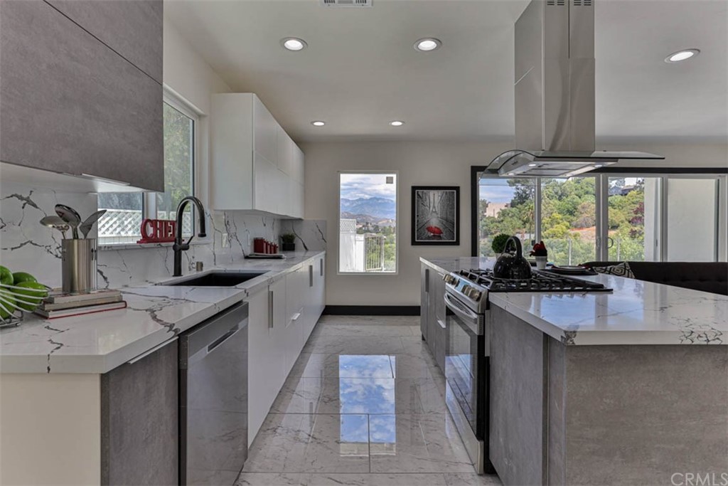945 Oban Drive Los Angeles, CA 90065 - Photo 10 of 60 a kitchen with stainless steel appliances granite countertop a sink stove and refrigerator