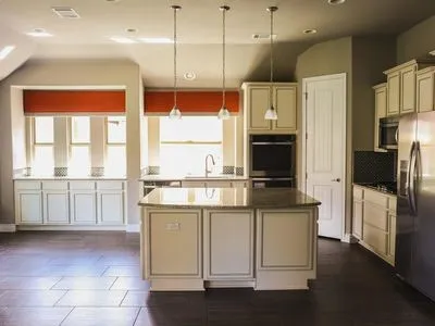 a kitchen with stainless steel appliances granite countertop a stove and a refrigerator