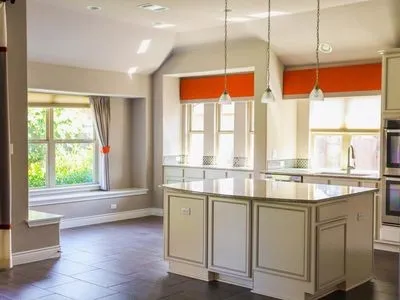 a kitchen with kitchen island and a large window