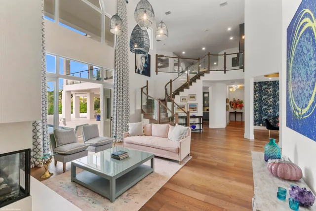 a living room with furniture a rug and a chandelier