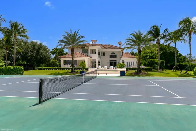 a view of a house with a swimming pool and a yard