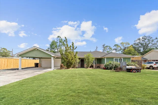 a front view of a house with a garden