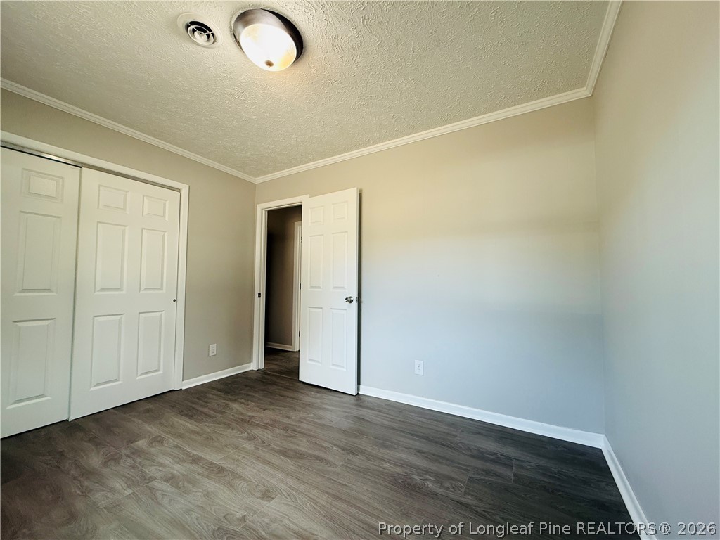 4736 Rosehill Road Fayetteville, NC 28311 - Photo 13 of 15 an empty room with wooden floor and windows