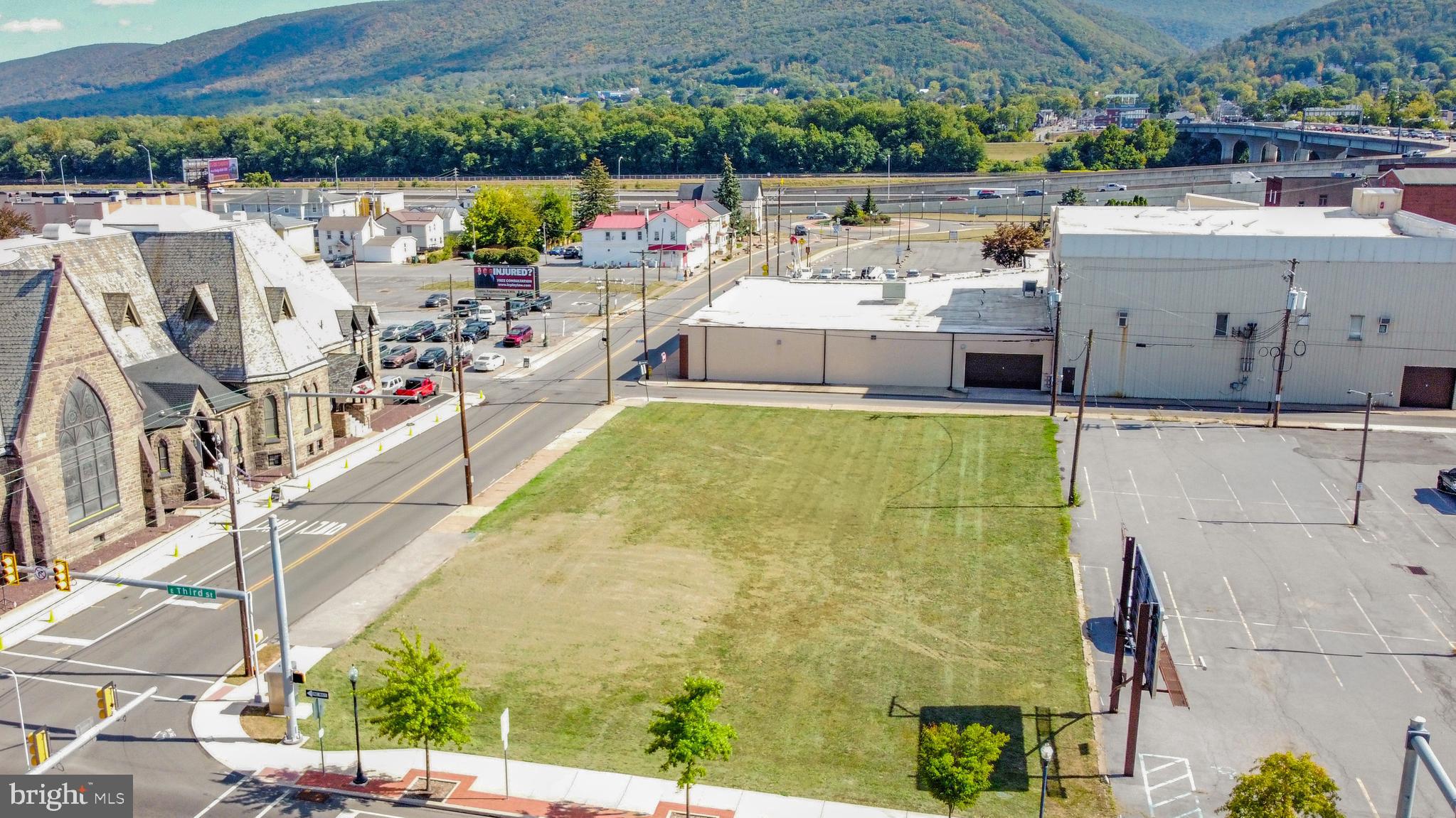 52 East 3rd Street Williamsport, PA 17701 - Photo 2 of 4 a view of a swimming pool with a lawn chairs under an umbrella