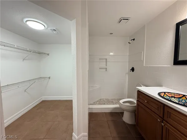 a bathroom with a sink a toilet and a shower